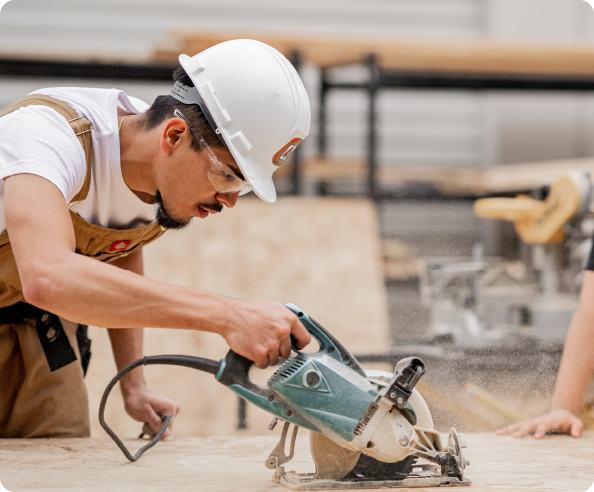 Photo of Man Cutting Wood with a Circular Saw