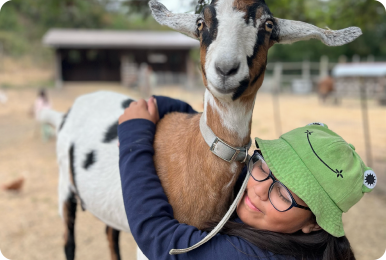 Photo of girl hugging a goat