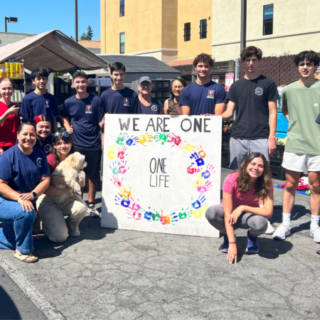 Photo of Youths with a sign that says We Are One - One Life