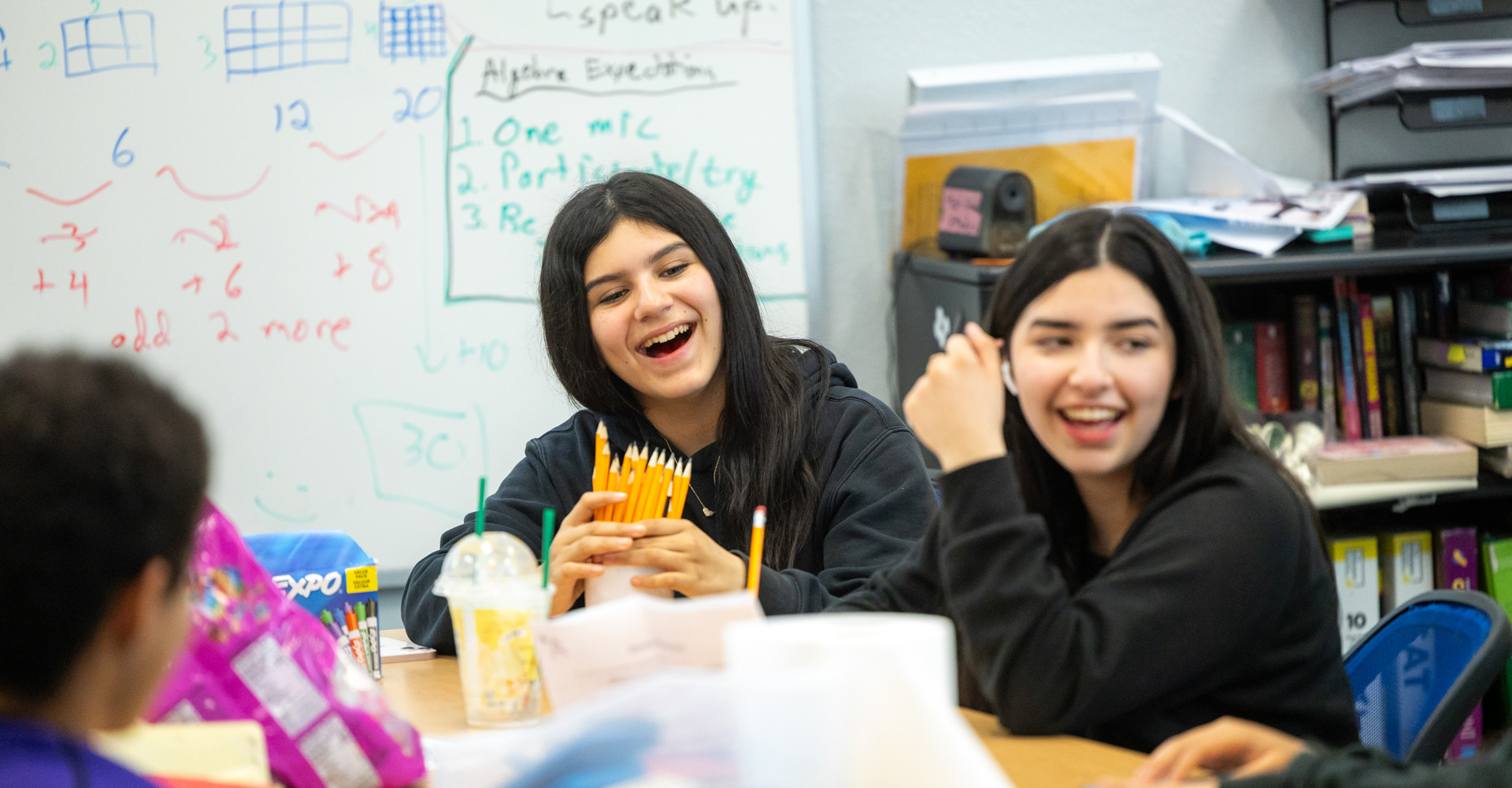 Photo of youth girls laughing in a classroom