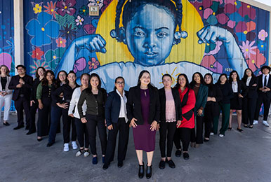 Photo of people in front of a mural