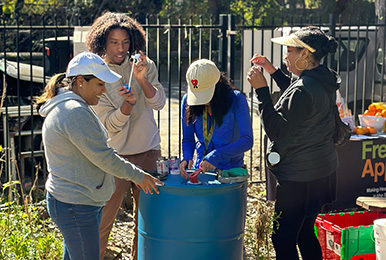 Photo of women around a rain barrel